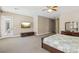 Comfortable main bedroom featuring a flat-screen TV, access to the backyard, and a dresser at 2197 Big Bar Dr, Henderson, NV 89052