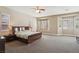 Spacious main bedroom featuring large windows, neutral decor, and a comfortable seating area at 2197 Big Bar Dr, Henderson, NV 89052