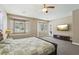 Bright main bedroom with a ceiling fan, backyard access, and large windows at 2197 Big Bar Dr, Henderson, NV 89052