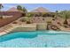 Inviting backyard pool featuring a waterfall and elevated spa at 2197 Big Bar Dr, Henderson, NV 89052