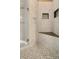 Modern bathroom shower with mosaic tile floor, marble walls, built-in bench, and shower niche at 2197 Big Bar Dr, Henderson, NV 89052