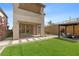 Lush backyard with artificial grass, covered patio, and pergola, perfect for outdoor relaxation and entertainment at 2367 Ridgeline Wash St, Las Vegas, NV 89138