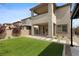 Beautiful backyard featuring a green lawn, patio, desert landscaping, and modern architecture at 2367 Ridgeline Wash St, Las Vegas, NV 89138