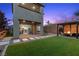 Inviting backyard with pavers, a pergola covered seating area with a fire pit, and lush artificial turf at 2367 Ridgeline Wash St, Las Vegas, NV 89138