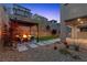 Cozy backyard features a fire pit, seating area, and low-maintenance landscaping in a modern home at 2367 Ridgeline Wash St, Las Vegas, NV 89138