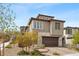 Charming home with stone accents, two-car garage, and a well-maintained front yard, offering curb appeal at 2367 Ridgeline Wash St, Las Vegas, NV 89138