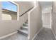 Hallway with carpet flooring, stairs, handrail, and natural light from window, and neutral colored walls at 2367 Ridgeline Wash St, Las Vegas, NV 89138
