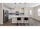 Modern kitchen featuring white cabinets, stainless steel appliances, and a quartz countertop island at 2367 Ridgeline Wash St, Las Vegas, NV 89138