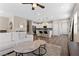 Open-concept living room with kitchen view, wood floors, and modern furnishings at 2367 Ridgeline Wash St, Las Vegas, NV 89138