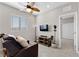 Comfortable living room featuring a recliner, TV, ceiling fan and adjacent doorway at 2367 Ridgeline Wash St, Las Vegas, NV 89138