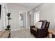 Comfortable living room with a recliner, planted tree, and doorway to another room at 2367 Ridgeline Wash St, Las Vegas, NV 89138