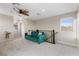 Inviting living room showcasing a plush green sofa, ceiling fan, and a large window for natural light at 2367 Ridgeline Wash St, Las Vegas, NV 89138