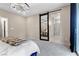 Primary bedroom with sliding barn door to bath, chandelier, and balcony access at 2367 Ridgeline Wash St, Las Vegas, NV 89138