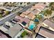 Aerial view of a neighborhood showcasing homes with tile roofs, backyard pools, and desert landscaping at 2470 Lothian St, Henderson, NV 89044