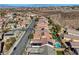 Aerial view showing a residential neighborhood with pools, landscaping, and desert hills in the background at 2470 Lothian St, Henderson, NV 89044