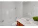 Clean, well-lit bathroom featuring a shower-tub combination and vanity with a large mirror at 2470 Lothian St, Henderson, NV 89044