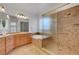 Luxurious bathroom featuring a large tub, tiled shower, double sinks, and custom lighting at 2470 Lothian St, Henderson, NV 89044