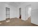 Spacious carpeted bedroom with a ceiling fan and attached bathroom at 2470 Lothian St, Henderson, NV 89044