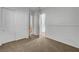 Bedroom featuring closet doors and a door to an adjacent room, with soft carpeting at 2470 Lothian St, Henderson, NV 89044