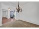 Open dining space with a chandelier, connecting to the entryway and creating a welcoming ambiance at 2470 Lothian St, Henderson, NV 89044