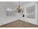 Bright dining room with modern chandelier and shuttered windows, offering ample natural light at 2470 Lothian St, Henderson, NV 89044