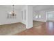 Open-concept dining room with chandelier and large windows, showcasing a bright and airy atmosphere at 2470 Lothian St, Henderson, NV 89044