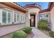 Inviting front entrance with a decorative glass door and lush landscaping at 2470 Lothian St, Henderson, NV 89044