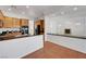 Beautiful kitchen with black appliances, stone countertops, and tile flooring leading to a living space at 2470 Lothian St, Henderson, NV 89044