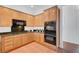 Efficient kitchen with light wood cabinetry, granite counters, and modern appliances for convenient cooking at 2470 Lothian St, Henderson, NV 89044