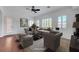 Bright living room with plantation shutters, a ceiling fan, ample seating, and a view to the entry at 2470 Lothian St, Henderson, NV 89044