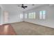 Well-lit living room with large windows and ceiling fan, creating a comfortable and airy atmosphere at 2470 Lothian St, Henderson, NV 89044