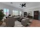 Inviting living room with plush seating, a ceiling fan, plantation shutters, and stylish decor at 2470 Lothian St, Henderson, NV 89044