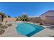 Backyard pool with desert landscaping, concrete patio, and a view of the home's exterior at 2470 Lothian St, Henderson, NV 89044