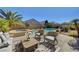 Inviting backyard oasis featuring a sparkling pool, spa, and comfortable outdoor seating area for relaxation at 2470 Lothian St, Henderson, NV 89044