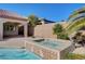 Integrated spa next to a pool, surrounded by desert landscaping and a block wall fence at 2470 Lothian St, Henderson, NV 89044