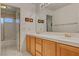 Well-lit bathroom featuring double sinks and a tiled shower at 2636 Ontario Dr, Las Vegas, NV 89128