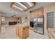 Open kitchen with granite countertops, stainless steel appliances, and island connected to living area at 2636 Ontario Dr, Las Vegas, NV 89128