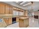 Well-lit kitchen featuring granite counters, wood cabinets, and center island with seating at 2636 Ontario Dr, Las Vegas, NV 89128