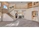 Bright and airy living room with staircase to the second level, a dining table, and neutral decor at 2636 Ontario Dr, Las Vegas, NV 89128