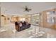 Living room features a tiled floor, ceiling fan, a couch, and sliding glass doors to outside at 2636 Ontario Dr, Las Vegas, NV 89128