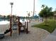 Community's lakeside playground features a sandy play area, slide, and shade structures for residents' enjoyment at 2636 Ontario Dr, Las Vegas, NV 89128