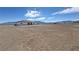 Expansive property showing the rear exterior of the home surrounded by mountain views and a blue sky at 2900 W Jaybird St, Pahrump, NV 89048