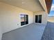 The covered back patio features dual sliding glass doors leading to the backyard and desert views at 2900 W Jaybird St, Pahrump, NV 89048