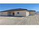 The back of the house has desert landscaping, a covered patio, and dual sliding glass doors at 2900 W Jaybird St, Pahrump, NV 89048