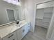 Modern bathroom vanity featuring quartz counters and access to a walk-in closet at 2900 W Jaybird St, Pahrump, NV 89048