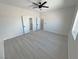 Large bedroom with multiple closets, gray floors, large window, and ceiling fan at 2900 W Jaybird St, Pahrump, NV 89048