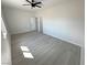 A spacious bedroom features light gray vinyl floors, a modern ceiling fan, and neutral paint throughout at 2900 W Jaybird St, Pahrump, NV 89048