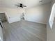 Spacious bedroom featuring modern ceiling fan, light gray flooring, and ensuite bathroom at 2900 W Jaybird St, Pahrump, NV 89048