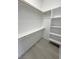 A walk-in closet with built-in shelving and wood rods provides ample storage space at 2900 W Jaybird St, Pahrump, NV 89048