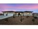 Charming single-story home featuring a three car garage, desert landscaping, and a modern front door at 2900 W Jaybird St, Pahrump, NV 89048